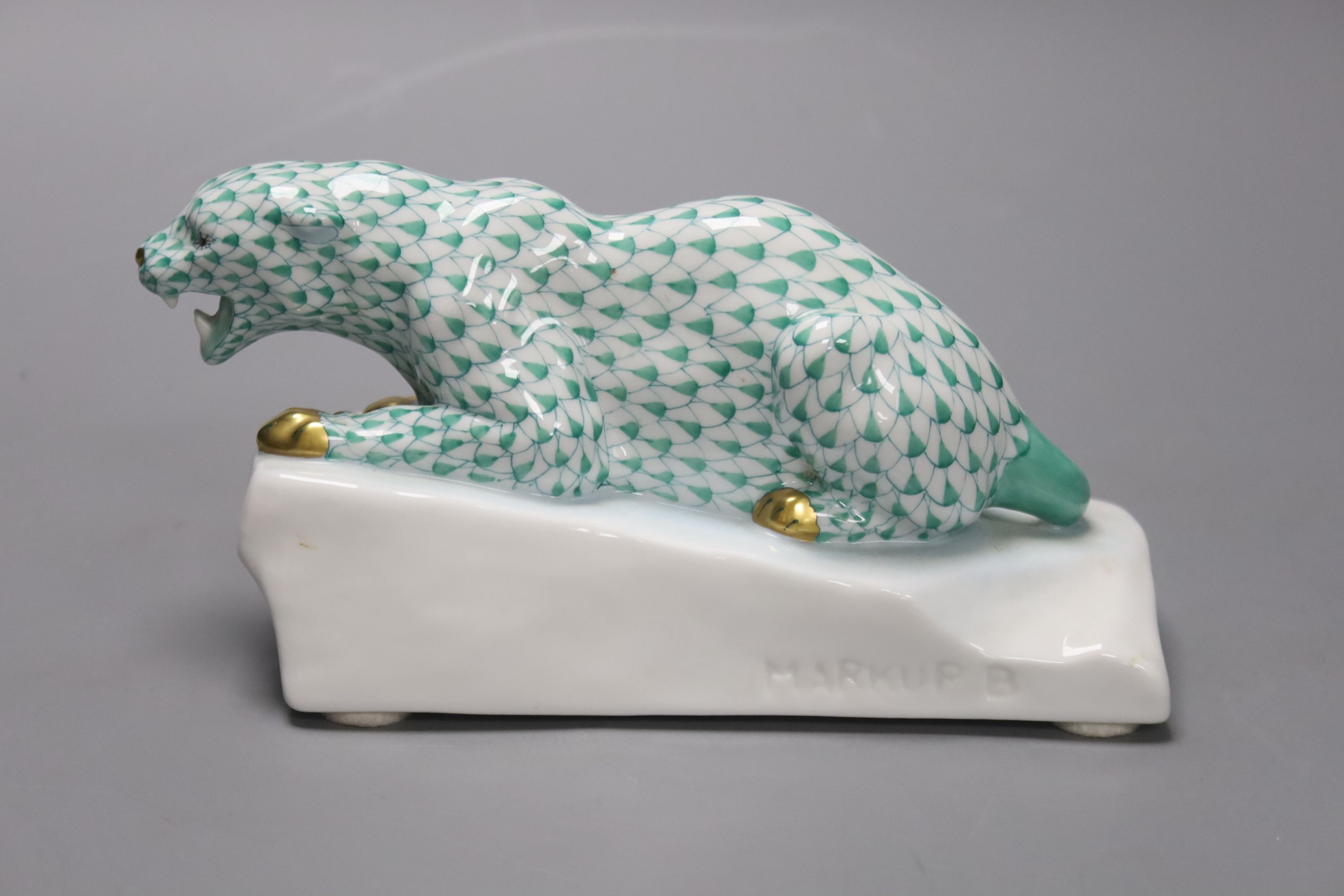 A Herend green ’fishnet’ model of a leopard crouching on a rock, signed Markup B